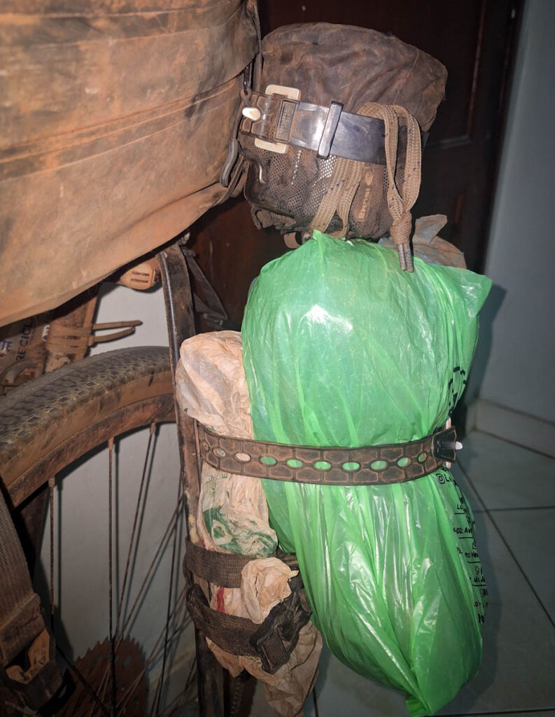 Fixplus strap securing extra items to a cargo cage on a loaded touring bike